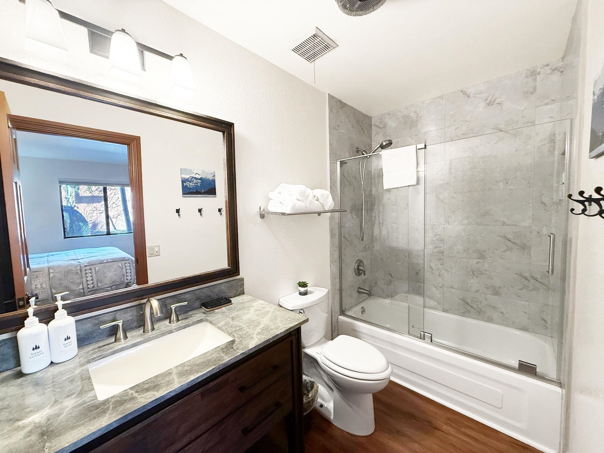 4710 Minaret Road, Unit 3 Mammoth Lakes, CA 93546 - Photo 13 of 30 a bathroom with a granite countertop sink toilet and shower