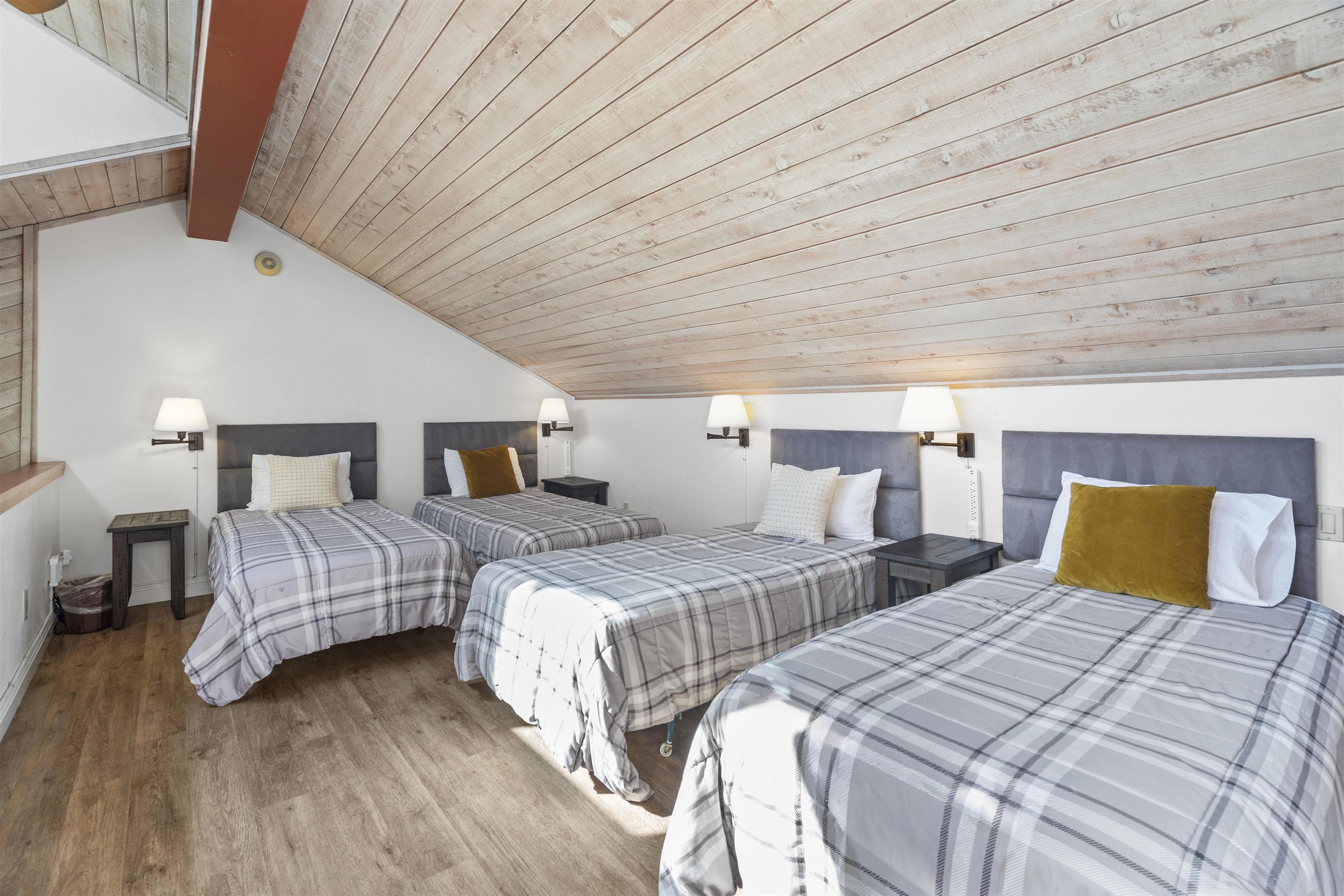 4710 Minaret Road, Unit 3 Mammoth Lakes, CA 93546 - Photo 21 of 30 a bedroom with two beds and painting on the wall