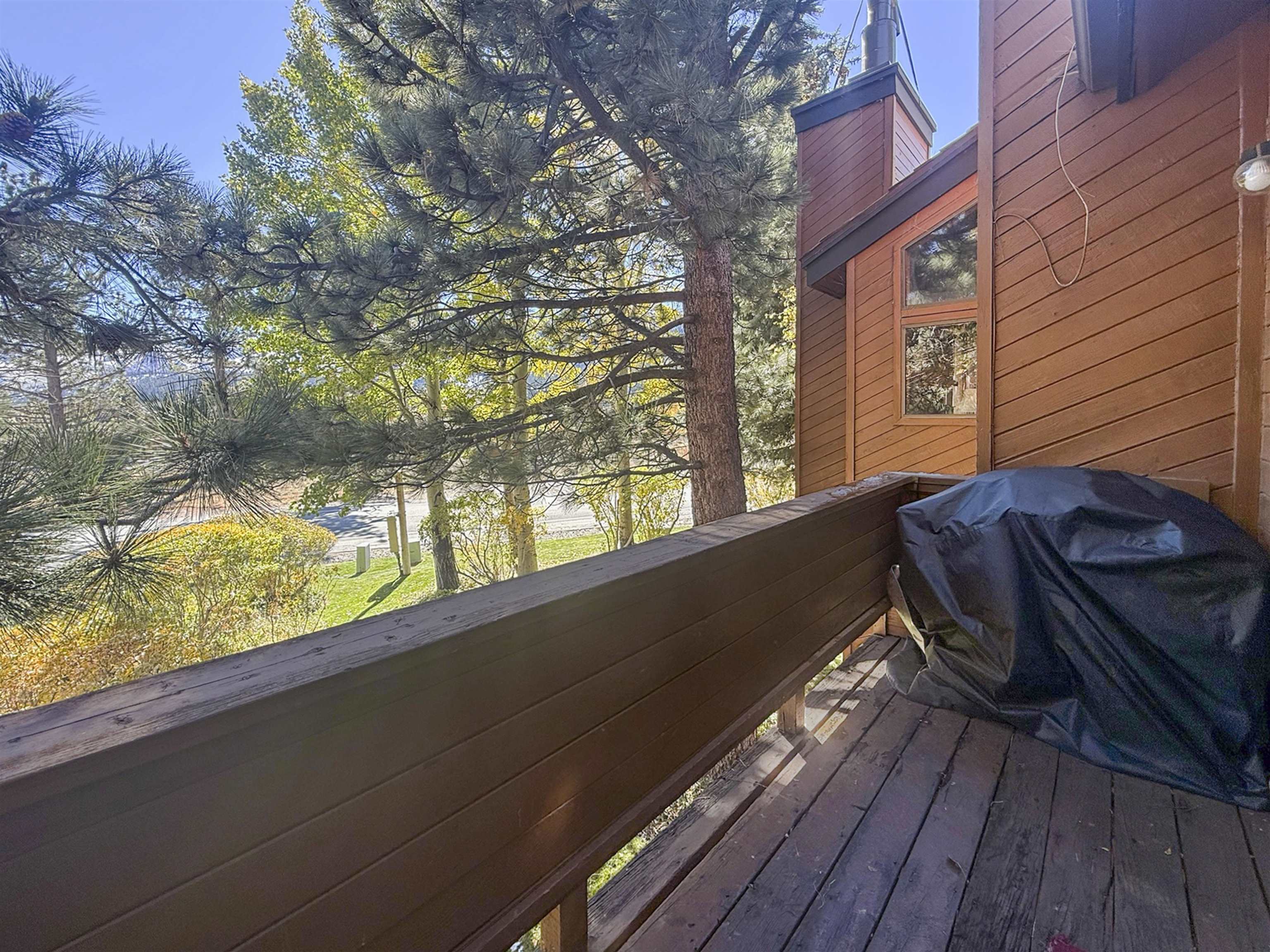 4710 Minaret Road, Unit 3 Mammoth Lakes, CA 93546 - Photo 27 of 30 a view of a roof deck with wooden floor and fence with a bench