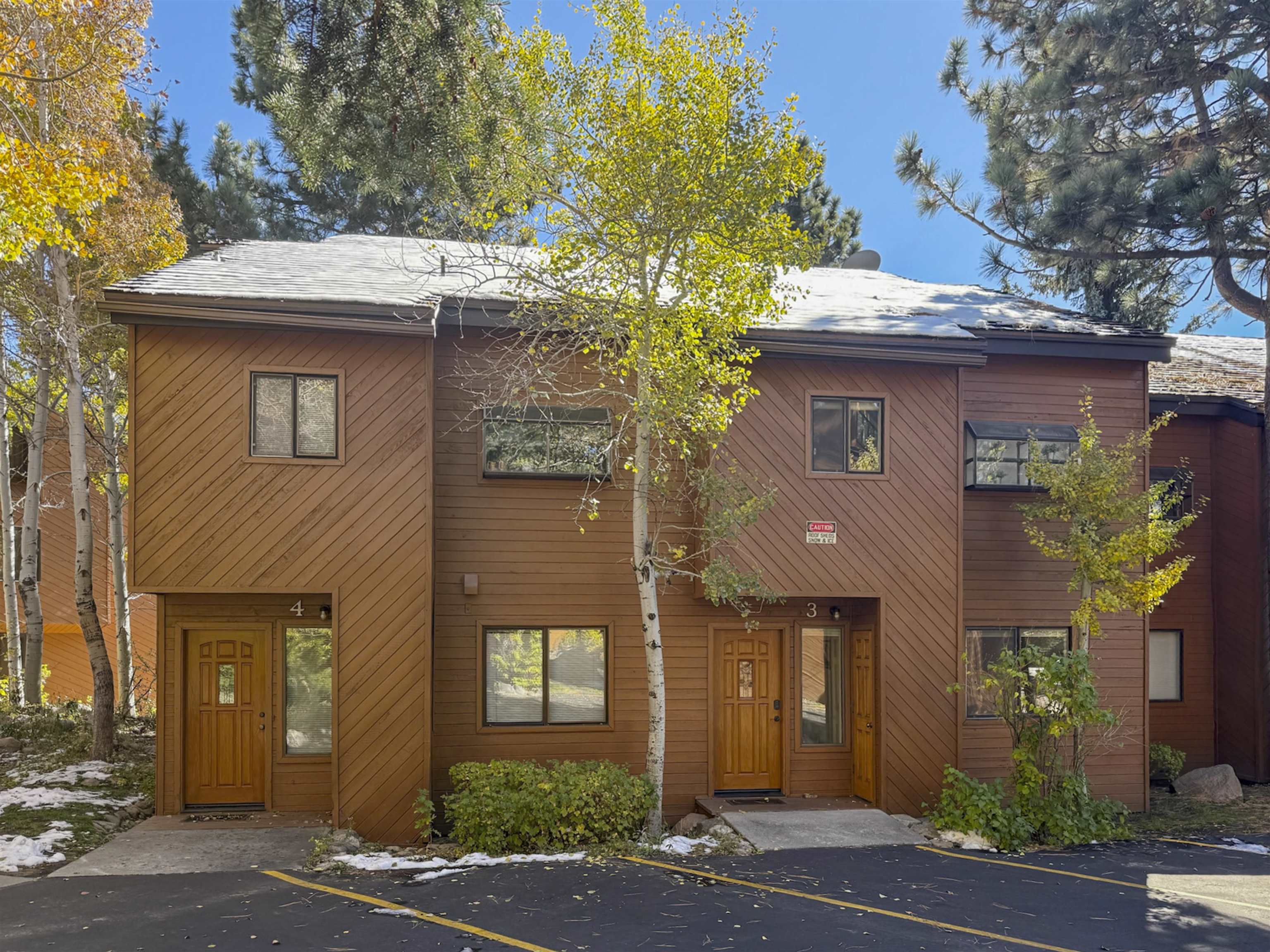 4710 Minaret Road, Unit 3 Mammoth Lakes, CA 93546 - Photo 29 of 30 a front view of a house with a yard garage and outdoor seating