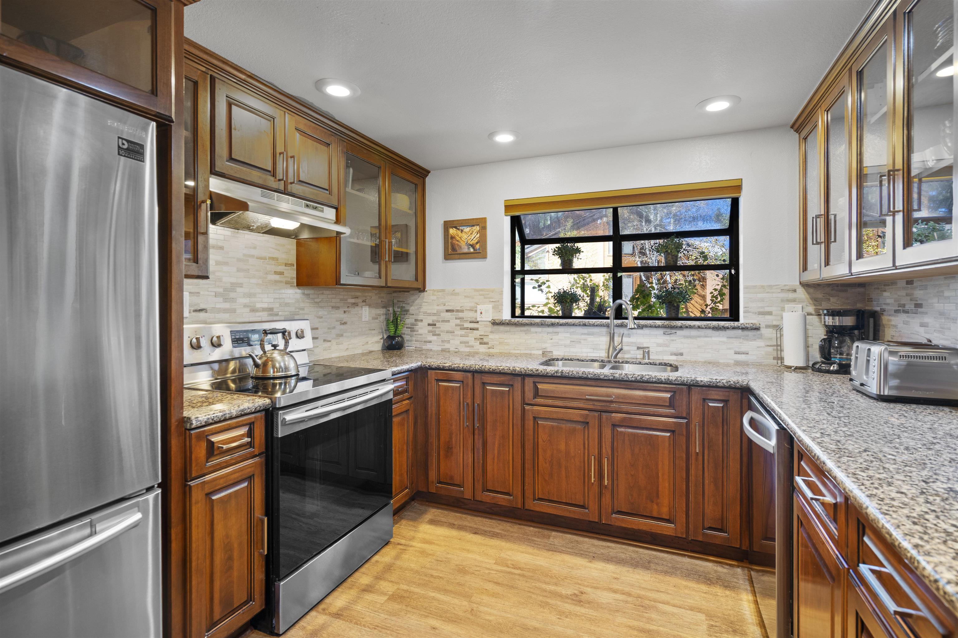 4710 Minaret Road, Unit 3 Mammoth Lakes, CA 93546 - Photo 5 of 30 a kitchen with stainless steel appliances granite countertop a sink stove and refrigerator