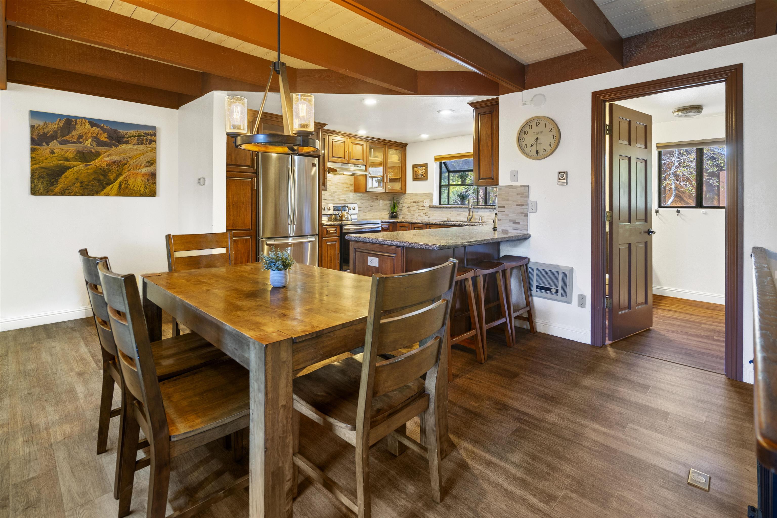 4710 Minaret Road, Unit 3 Mammoth Lakes, CA 93546 - Photo 6 of 30 a dining area with stainless steel appliances kitchen island a table and chairs