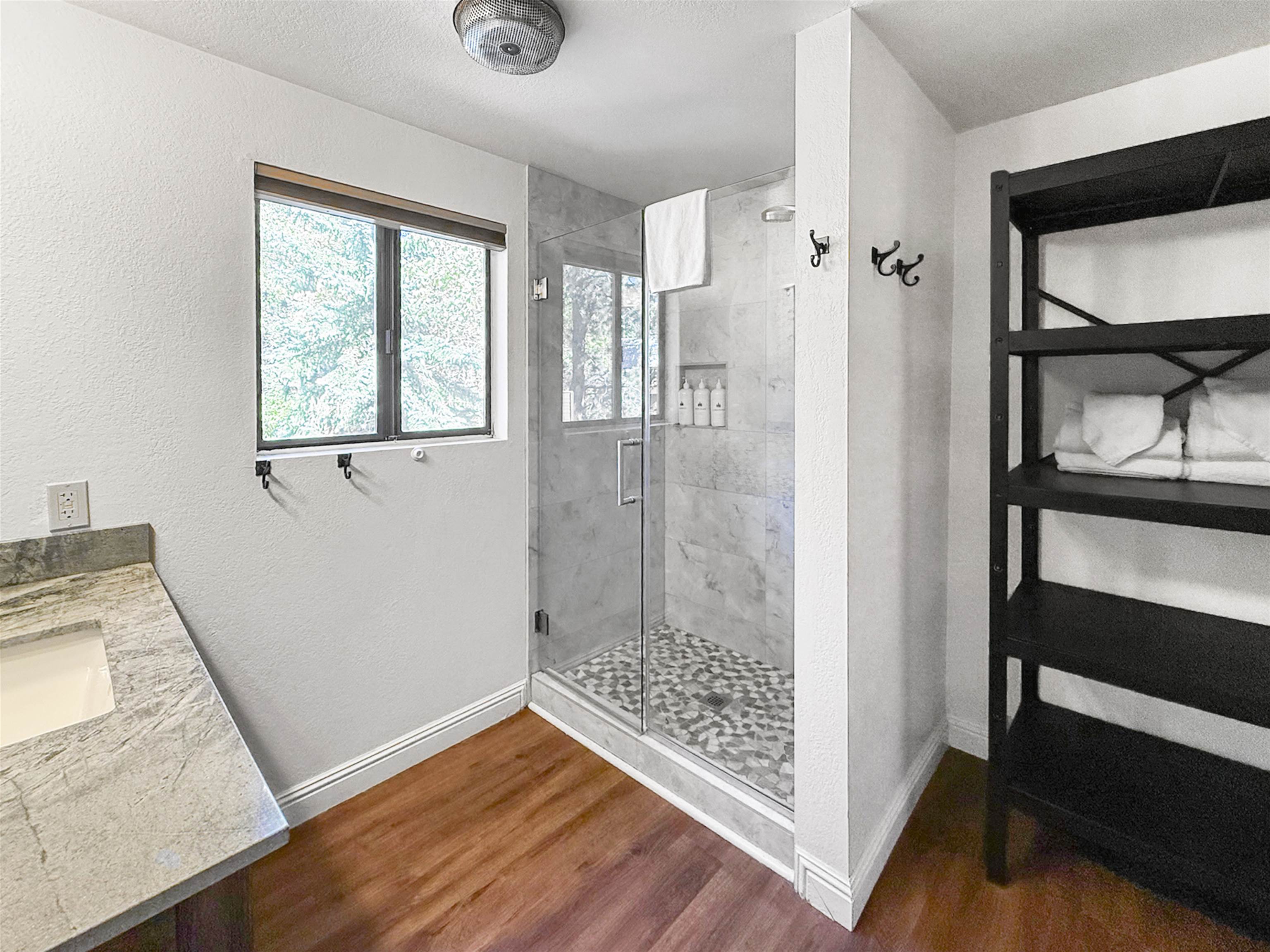4710 Minaret Road, Unit 3 Mammoth Lakes, CA 93546 - Photo 8 of 30 a bathroom with a glass shower door and a window