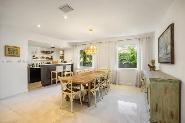 a kitchen with a sink a cabinets and wooden floor