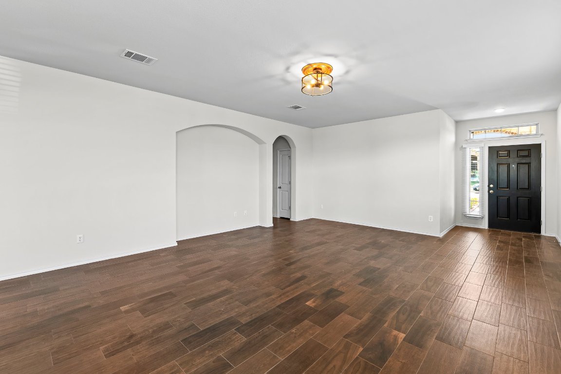704 Coltrane Drive Pflugerville, TX 78660 - Photo 11 of 39 a view of empty room with wooden floor
