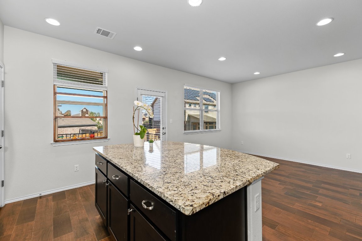 704 Coltrane Drive Pflugerville, TX 78660 - Photo 19 of 39 a kitchen with center island table and chairs