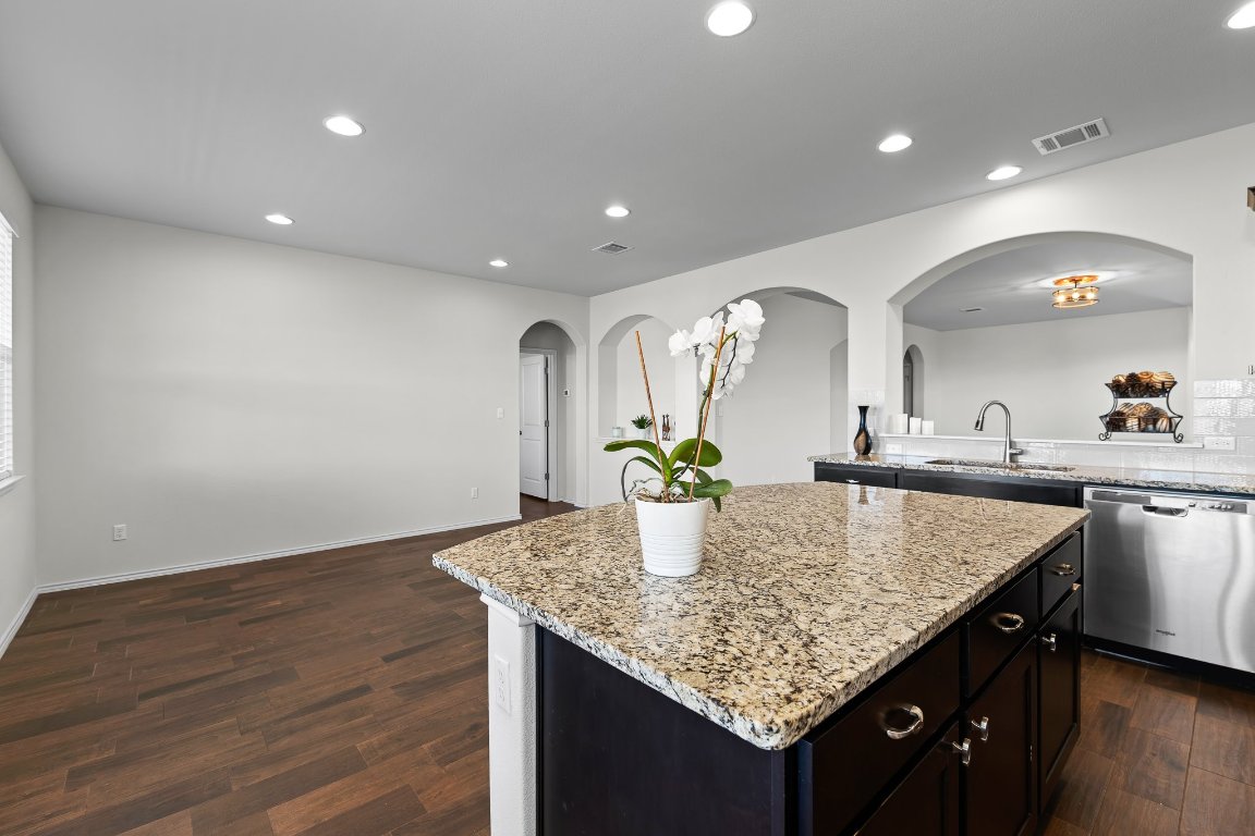 704 Coltrane Drive Pflugerville, TX 78660 - Photo 20 of 39 a kitchen with center island table and wooden floor