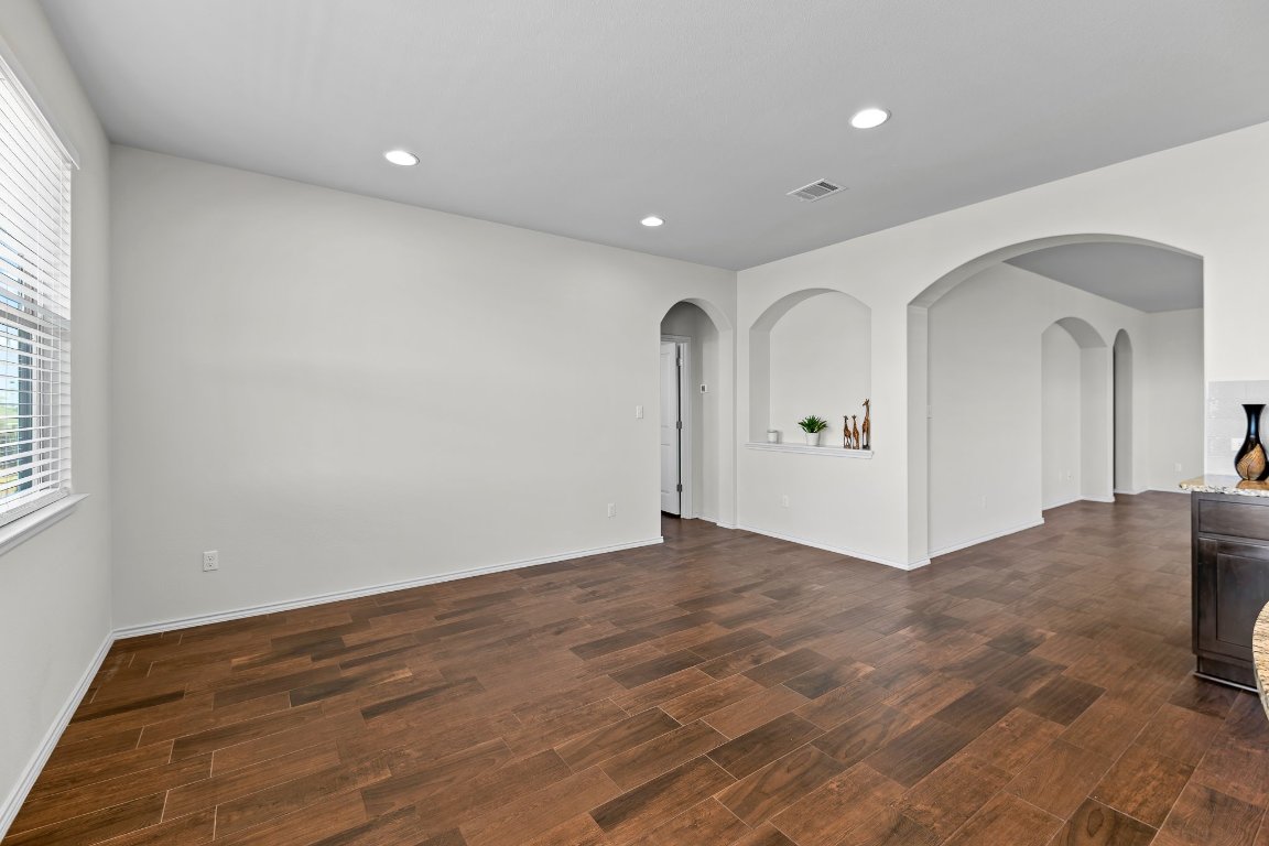 704 Coltrane Drive Pflugerville, TX 78660 - Photo 21 of 39 a view of a livingroom with wooden floor and window