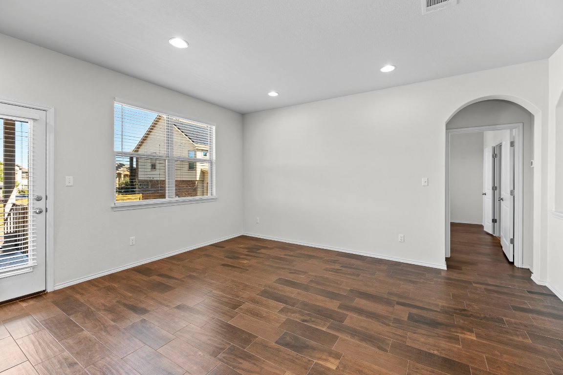 704 Coltrane Drive Pflugerville, TX 78660 - Photo 22 of 39 an empty room with wooden floor and windows