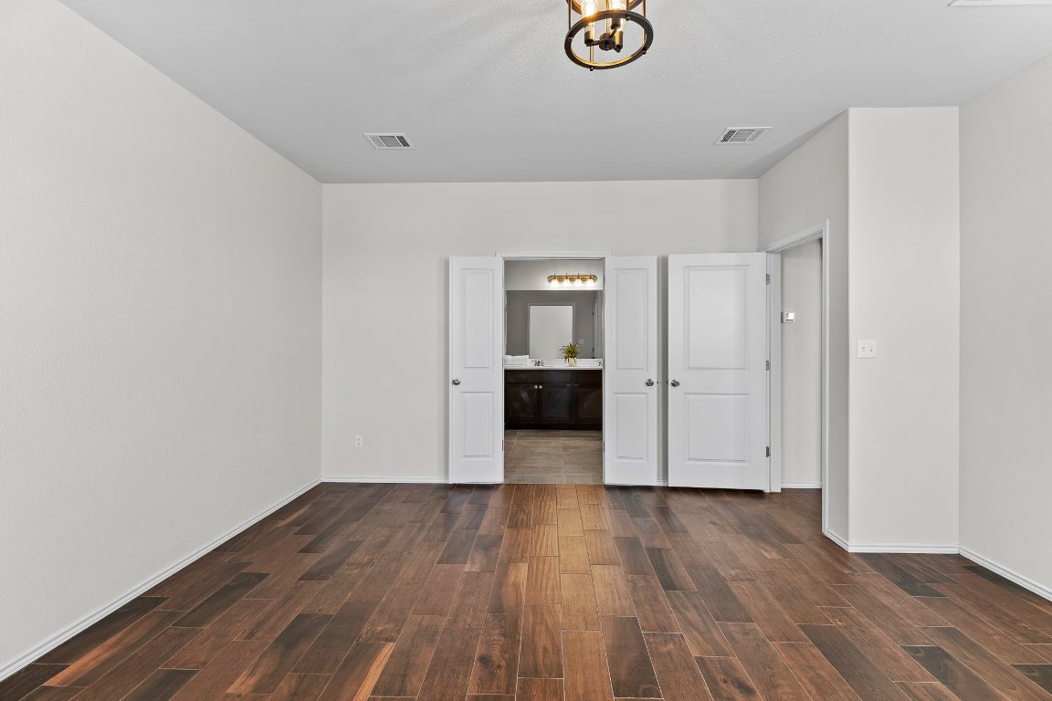 704 Coltrane Drive Pflugerville, TX 78660 - Photo 24 of 39 a view of empty room with wooden floor