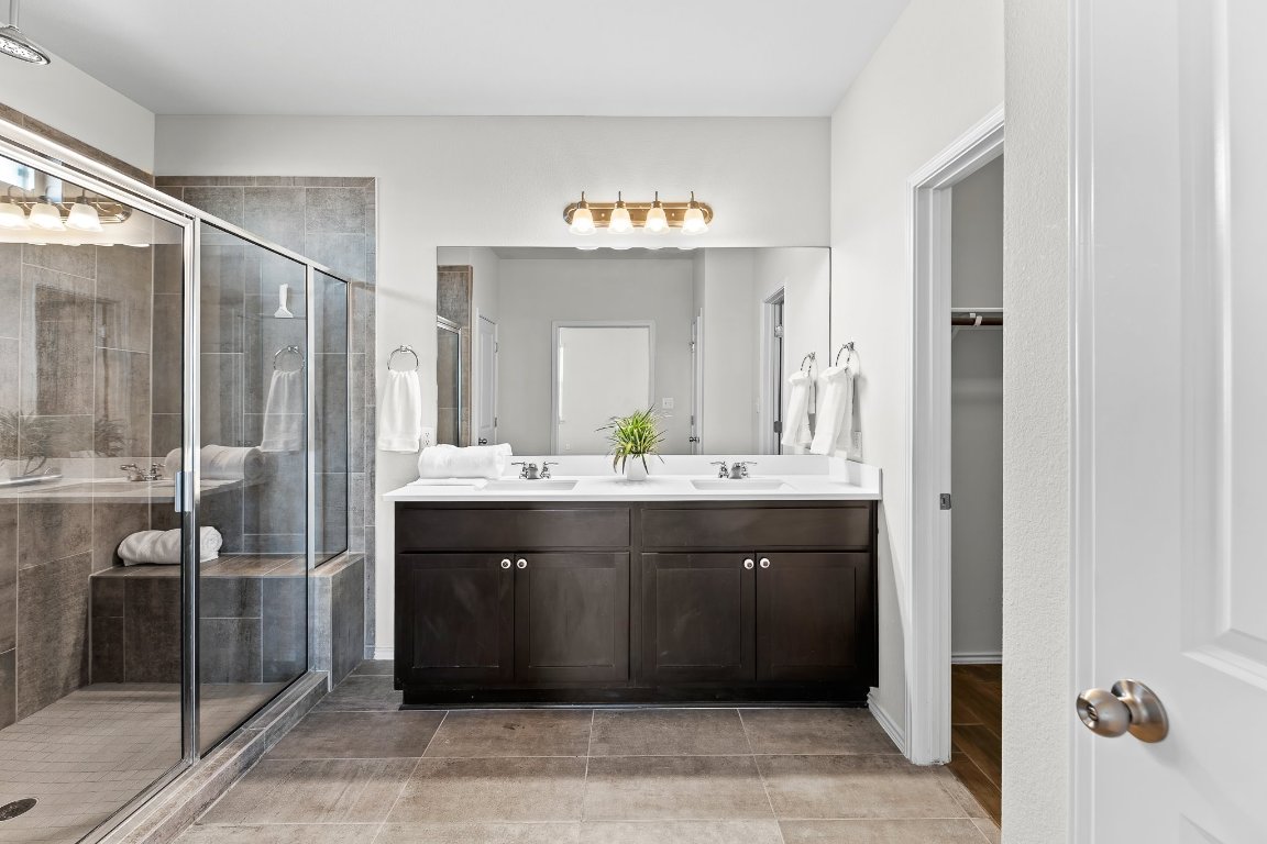 704 Coltrane Drive Pflugerville, TX 78660 - Photo 25 of 39 a bathroom with a sink and a mirror