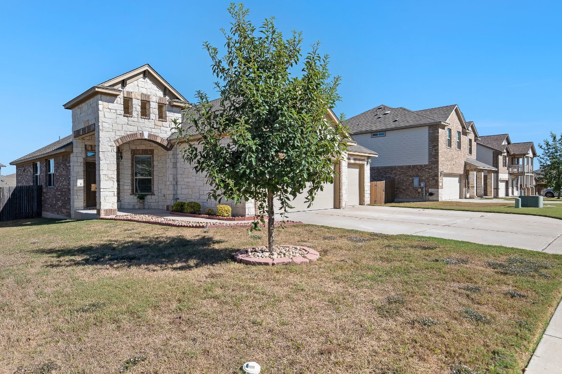 704 Coltrane Drive Pflugerville, TX 78660 - Photo 3 of 39 a front view of a house with a yard