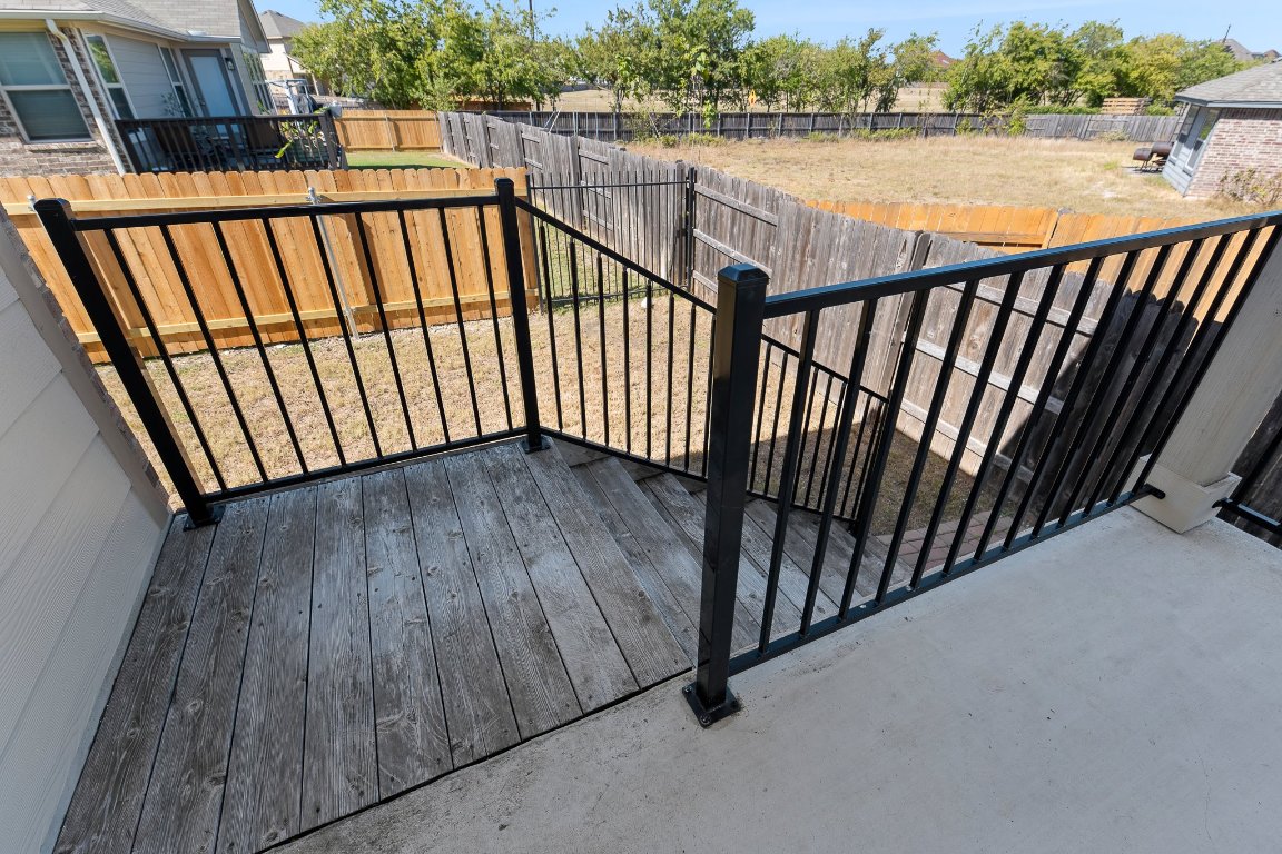 704 Coltrane Drive Pflugerville, TX 78660 - Photo 34 of 39 a view of a balcony with wooden floor