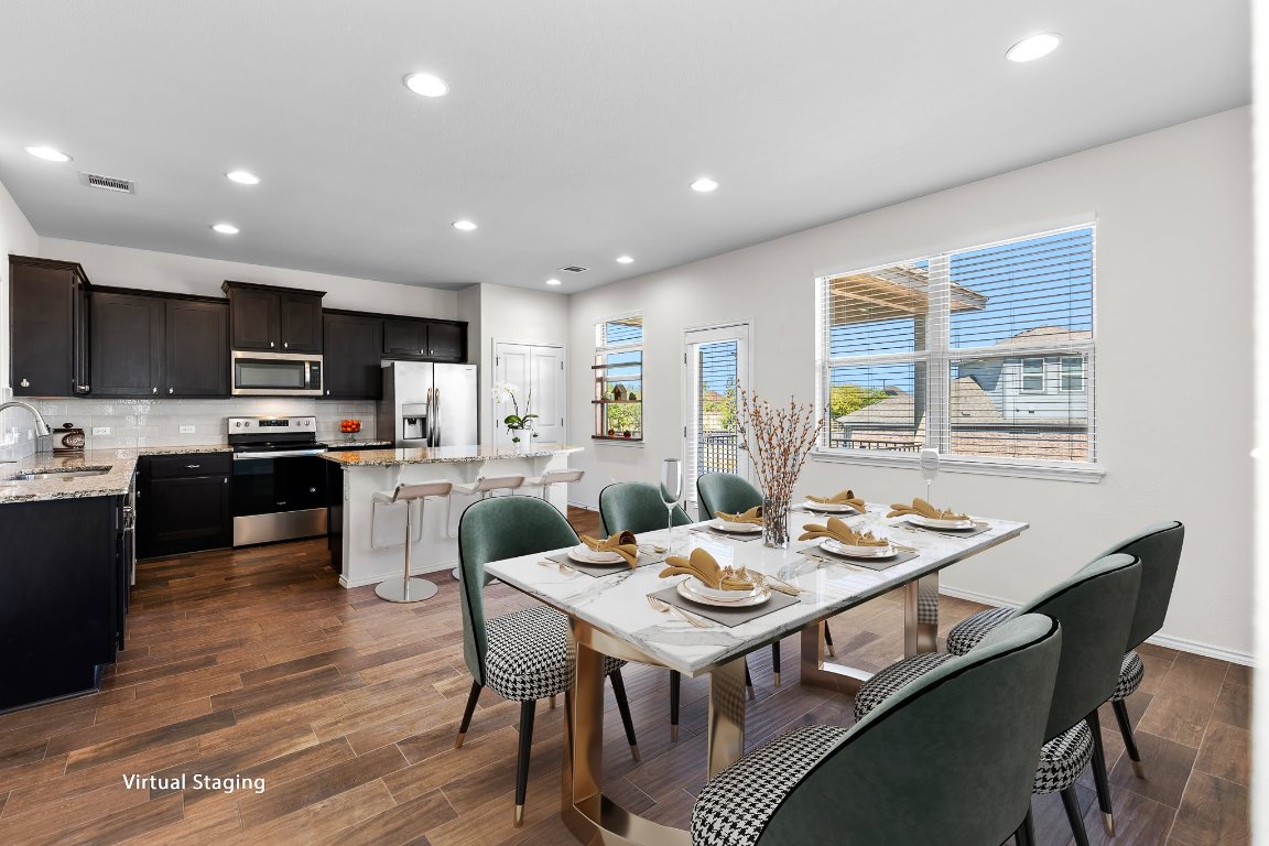 704 Coltrane Drive Pflugerville, TX 78660 - Photo 6 of 39 a kitchen with a dining table chairs and refrigerator