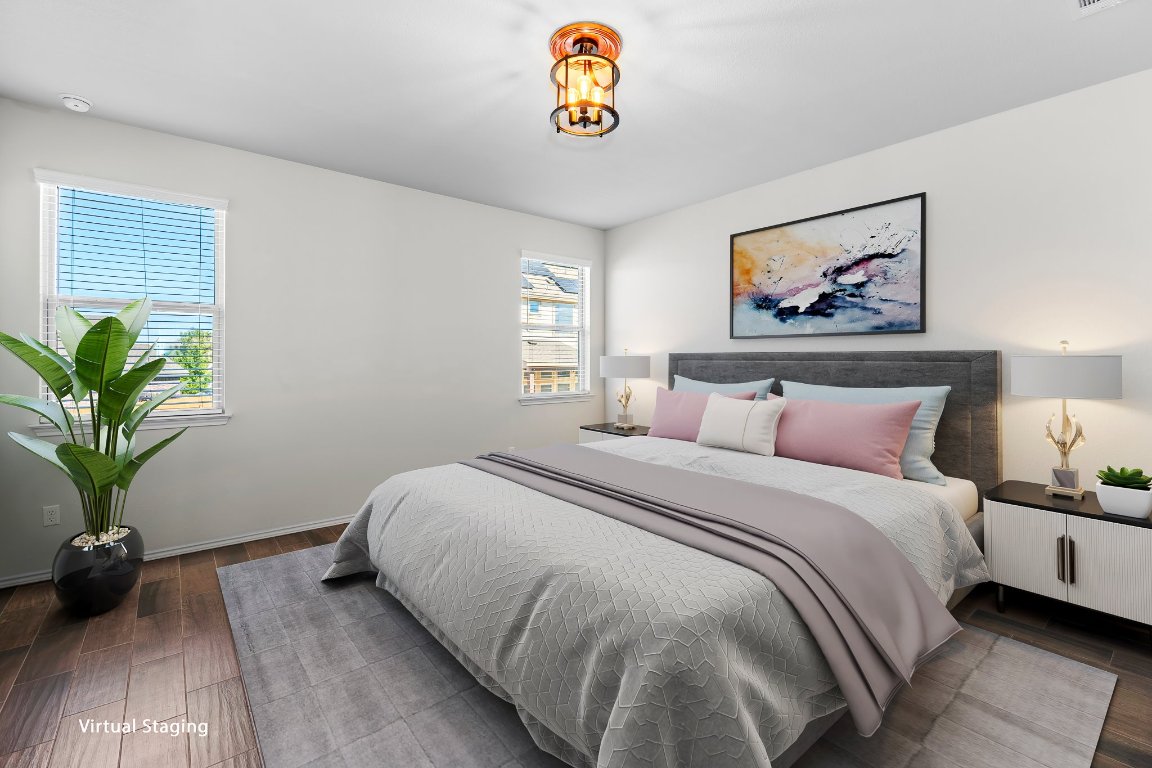 704 Coltrane Drive Pflugerville, TX 78660 - Photo 7 of 39 a bedroom with a bed and a potted plant