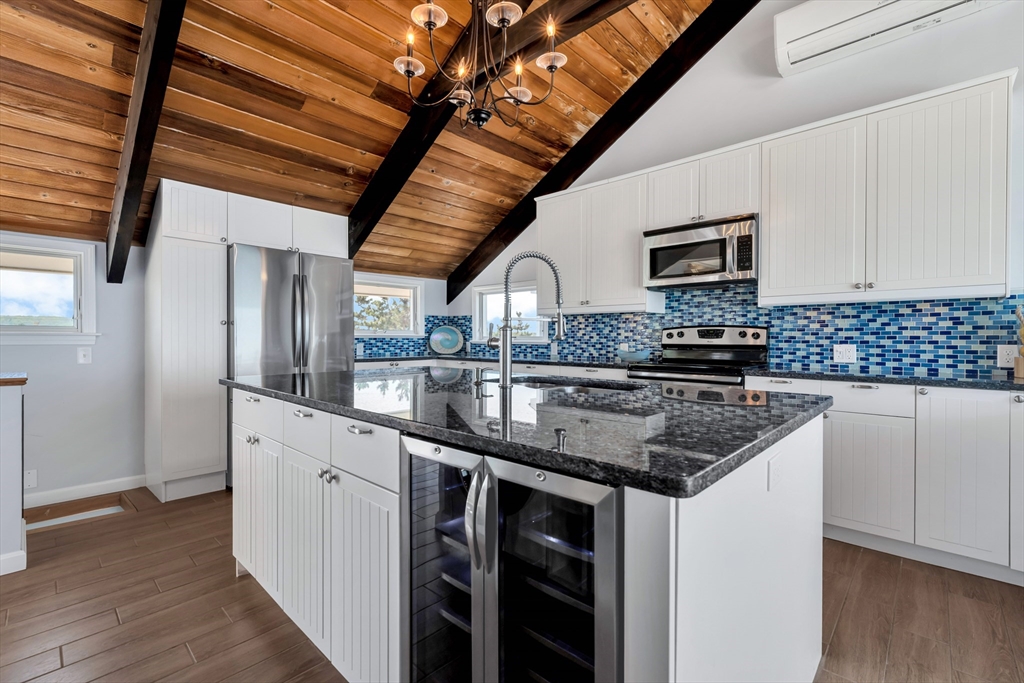 90 Salt Marsh Road East Sandwich, MA 02537 - Photo 12 of 40 a kitchen with stainless steel appliances granite countertop a sink stove and cabinets