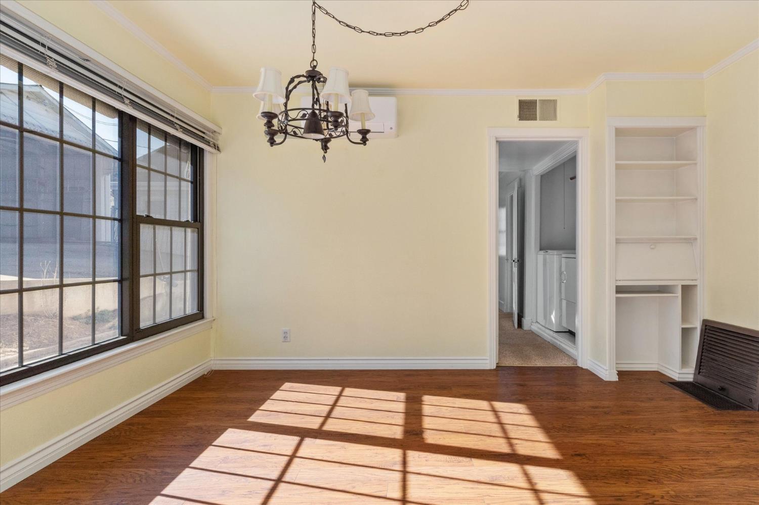 1575 South Main Street Angels Camp, CA 95222 - Photo 13 of 39 a view of a bedroom with wooden floor and windows