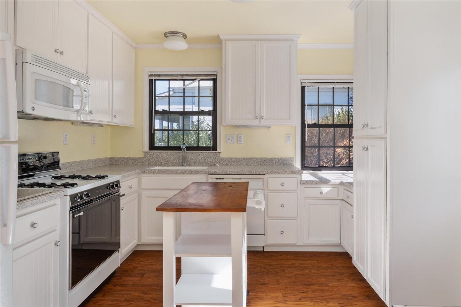1575 South Main Street Angels Camp, CA 95222 - Photo 16 of 39 a kitchen with stainless steel appliances granite countertop a stove and a refrigerator