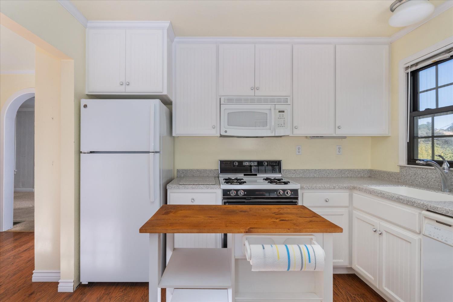 1575 South Main Street Angels Camp, CA 95222 - Photo 17 of 39 a kitchen with stainless steel appliances granite countertop refrigerator sink and cabinets