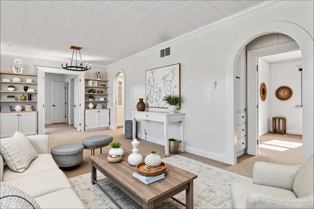 a view of an empty room with glass door and windows