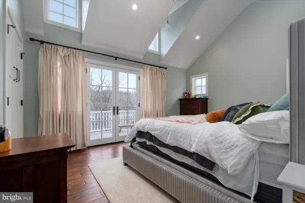a bedroom with a bed and a large window