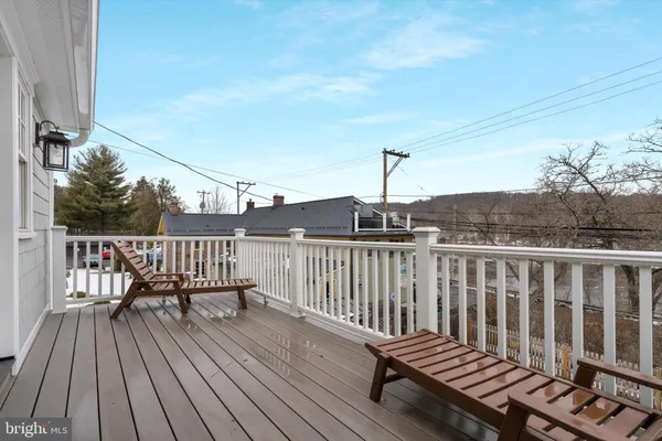 a view of balcony with wooden floor and fence