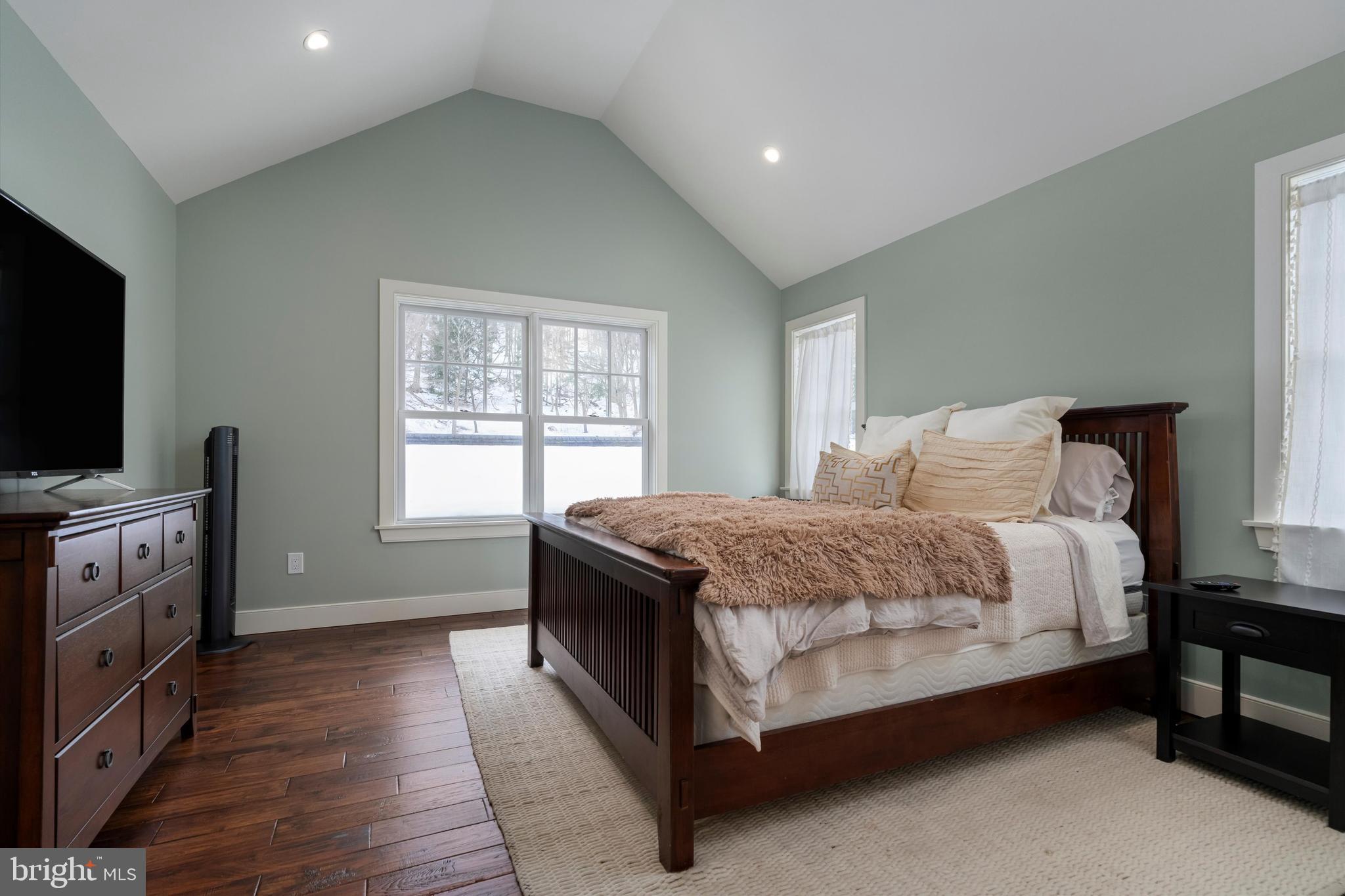 3741 River Road Lumberville, PA 18933 - Photo 25 of 31 a spacious bedroom with a bed and a flat screen tv