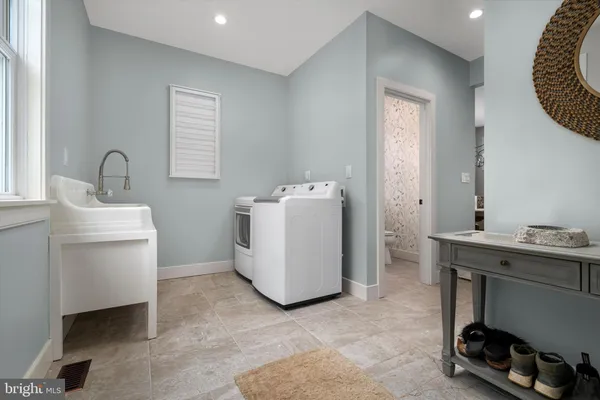a utility room with sink dryer and washer