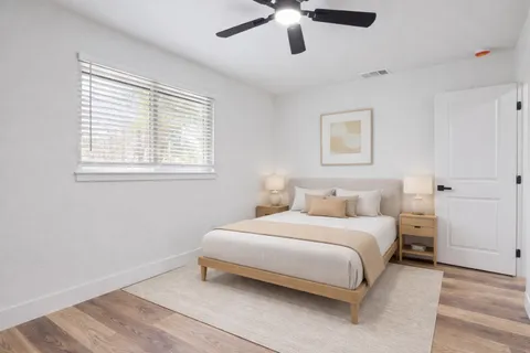 a bedroom with a bed and a window