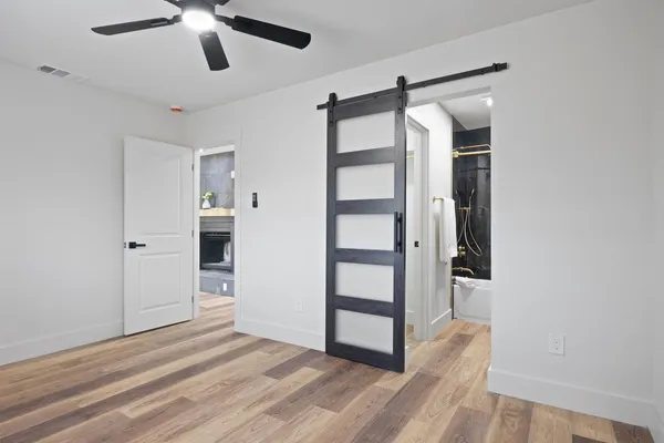 a view of a room with closet and chandelier fan