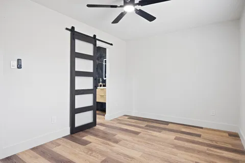 a view of empty room with wooden floor