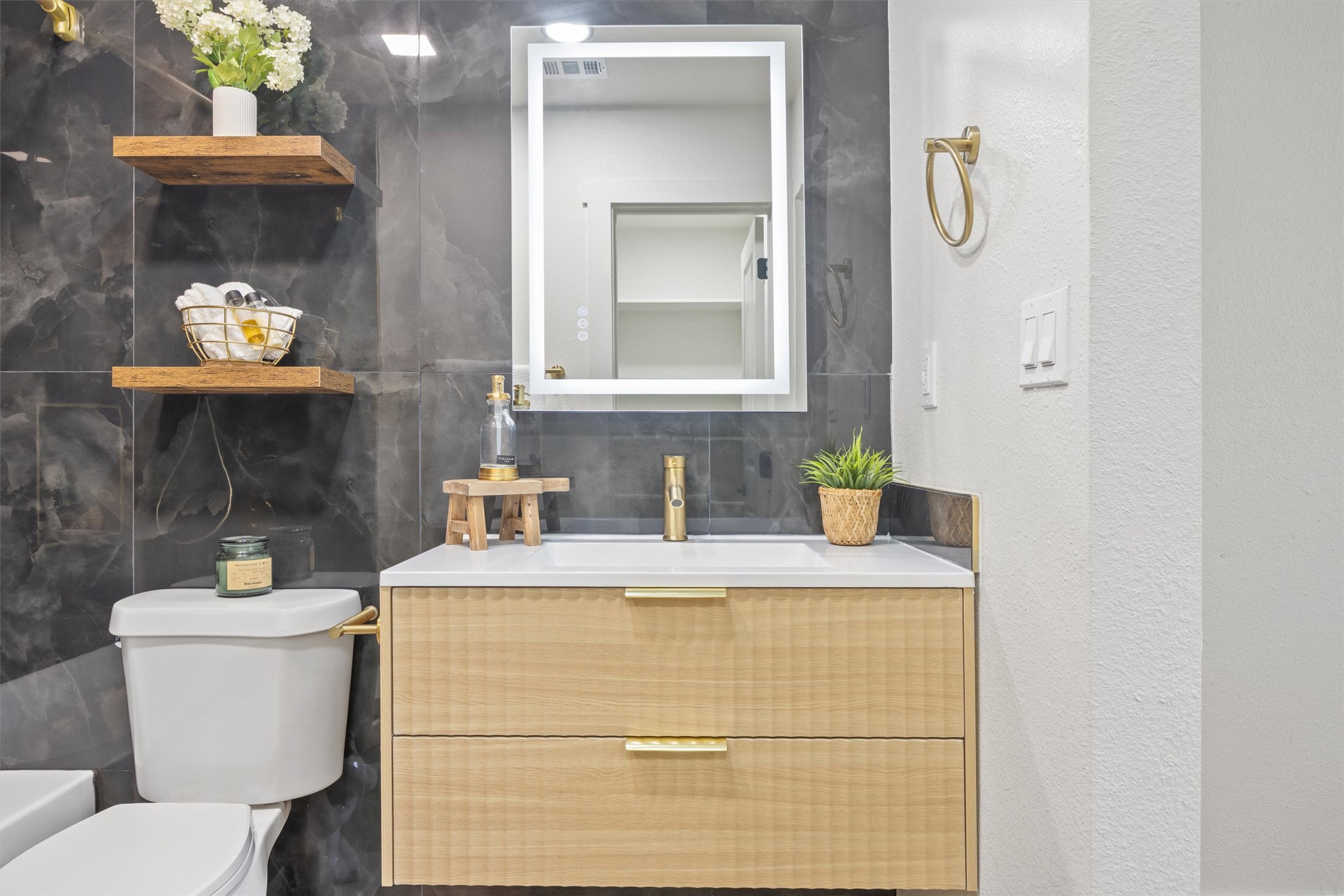 6212 Boxcar Run Austin, TX 78745 - Photo 21 of 36 Bathroom with vanity, decorative backsplash, and a textured wall