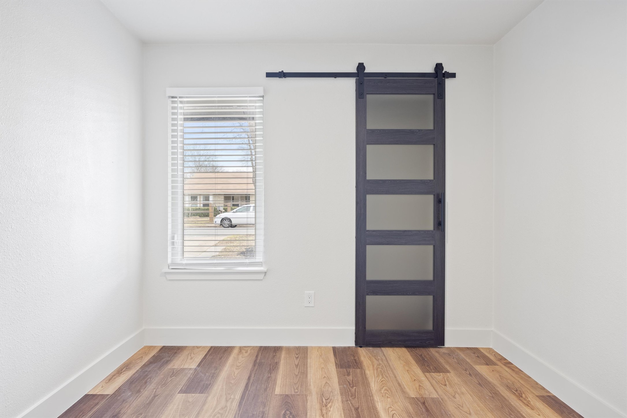 6212 Boxcar Run Austin, TX 78745 - Photo 25 of 36 Entryway featuring a barn door and wood finished floors