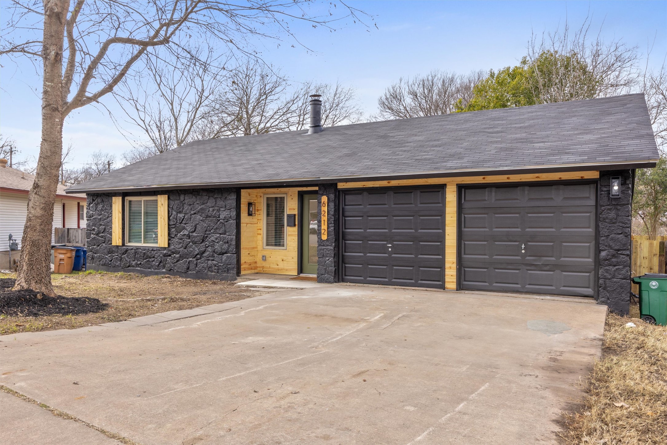 6212 Boxcar Run Austin, TX 78745 - Photo 3 of 36 View of front of house with stone siding, concrete driveway, a garage, and a shingled roof