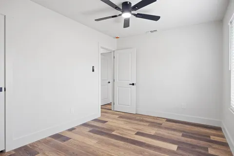 a view of a room with a ceiling fan