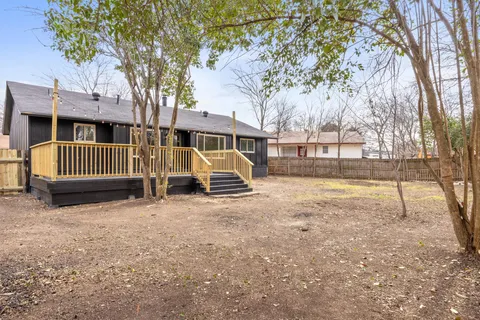 a view of a house with a yard and sitting area