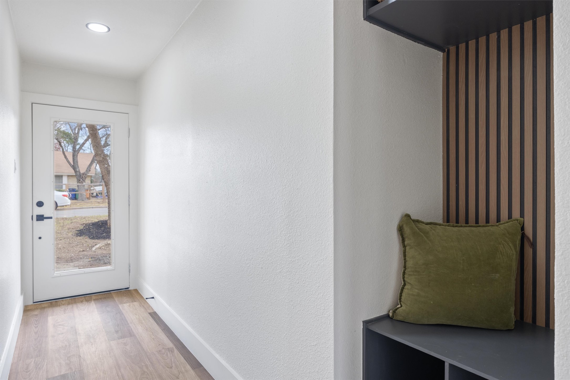 6212 Boxcar Run Austin, TX 78745 - Photo 4 of 36 Doorway to outside with wood finished floors, a textured wall, and recessed lighting