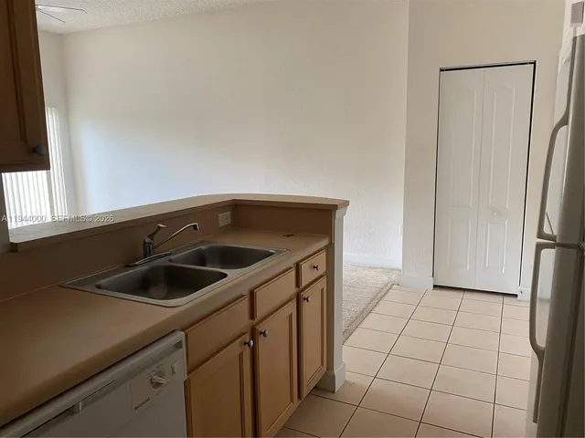 a kitchen with a sink and refrigerator