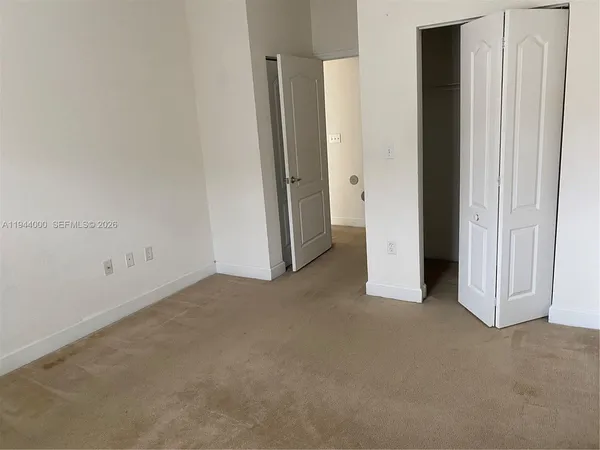 an empty room with closet area