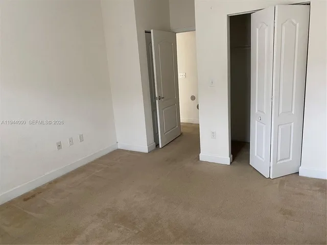 an empty room with closet area