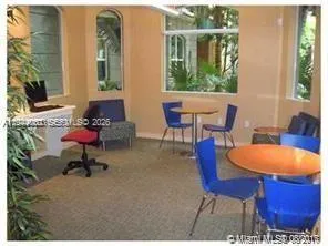 a living room with furniture a window and a potted plant