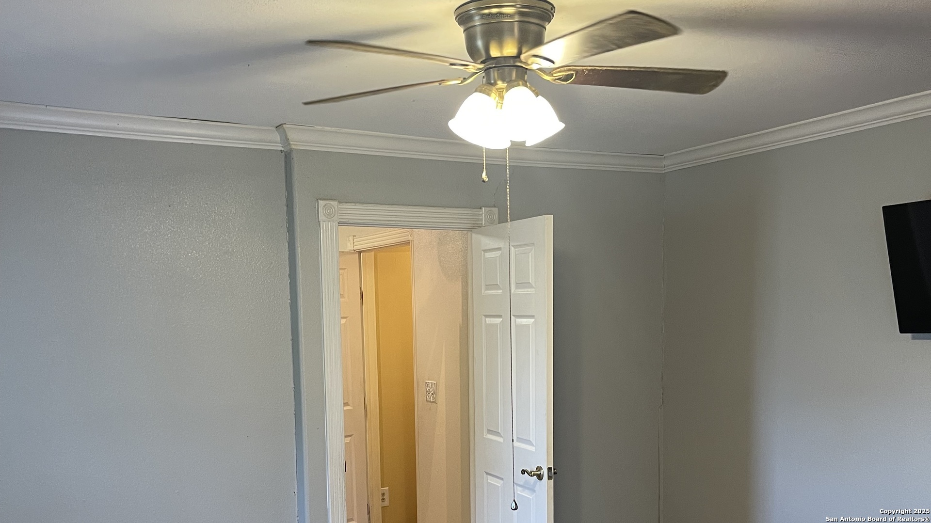 6932 Green Valley Road Cibolo, TX 78108 - Photo 14 of 18 a view of a chandelier fan and a refrigerator