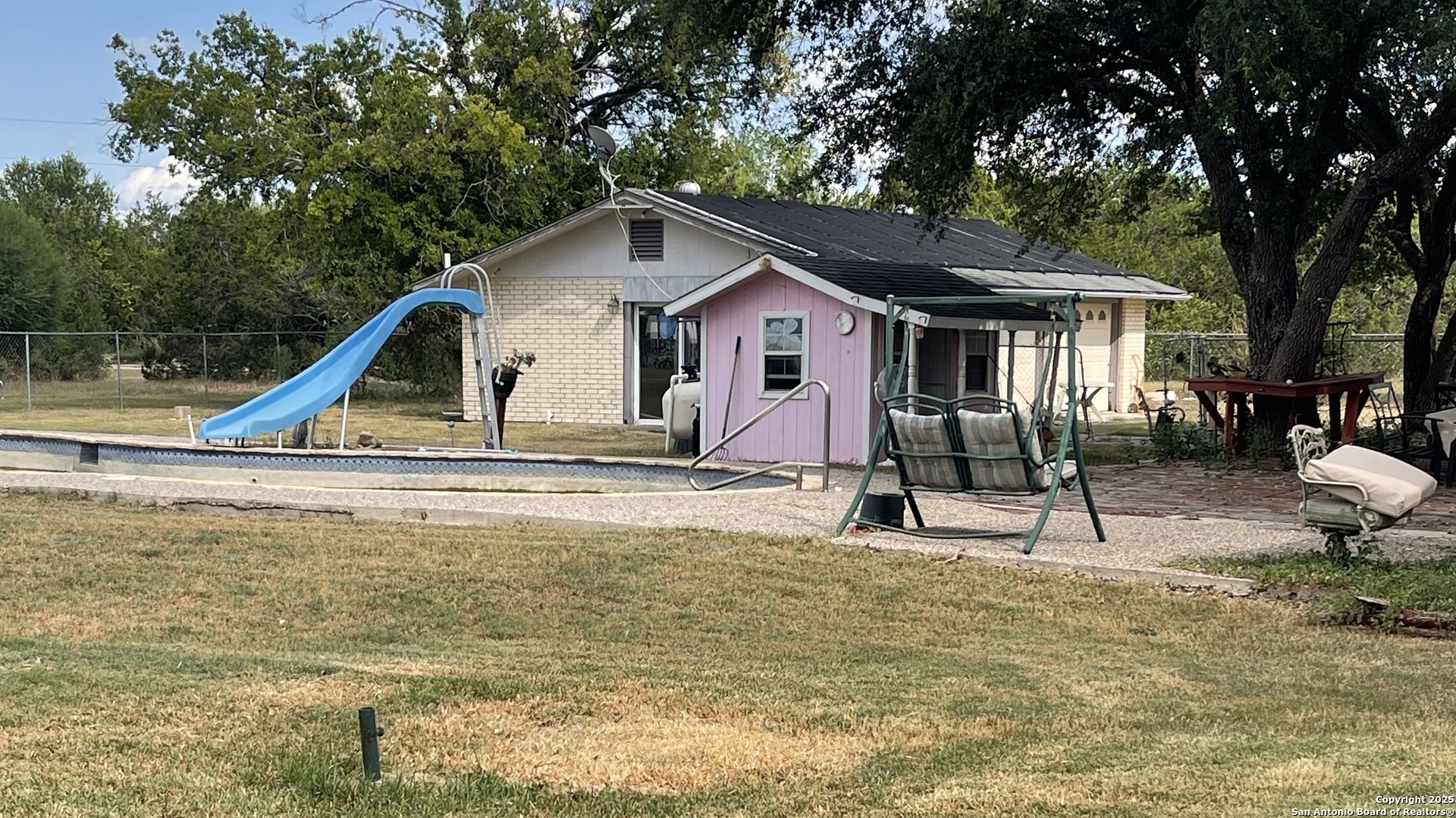 6932 Green Valley Road Cibolo, TX 78108 - Photo 5 of 18 a swimming pool with outdoor seating and yard