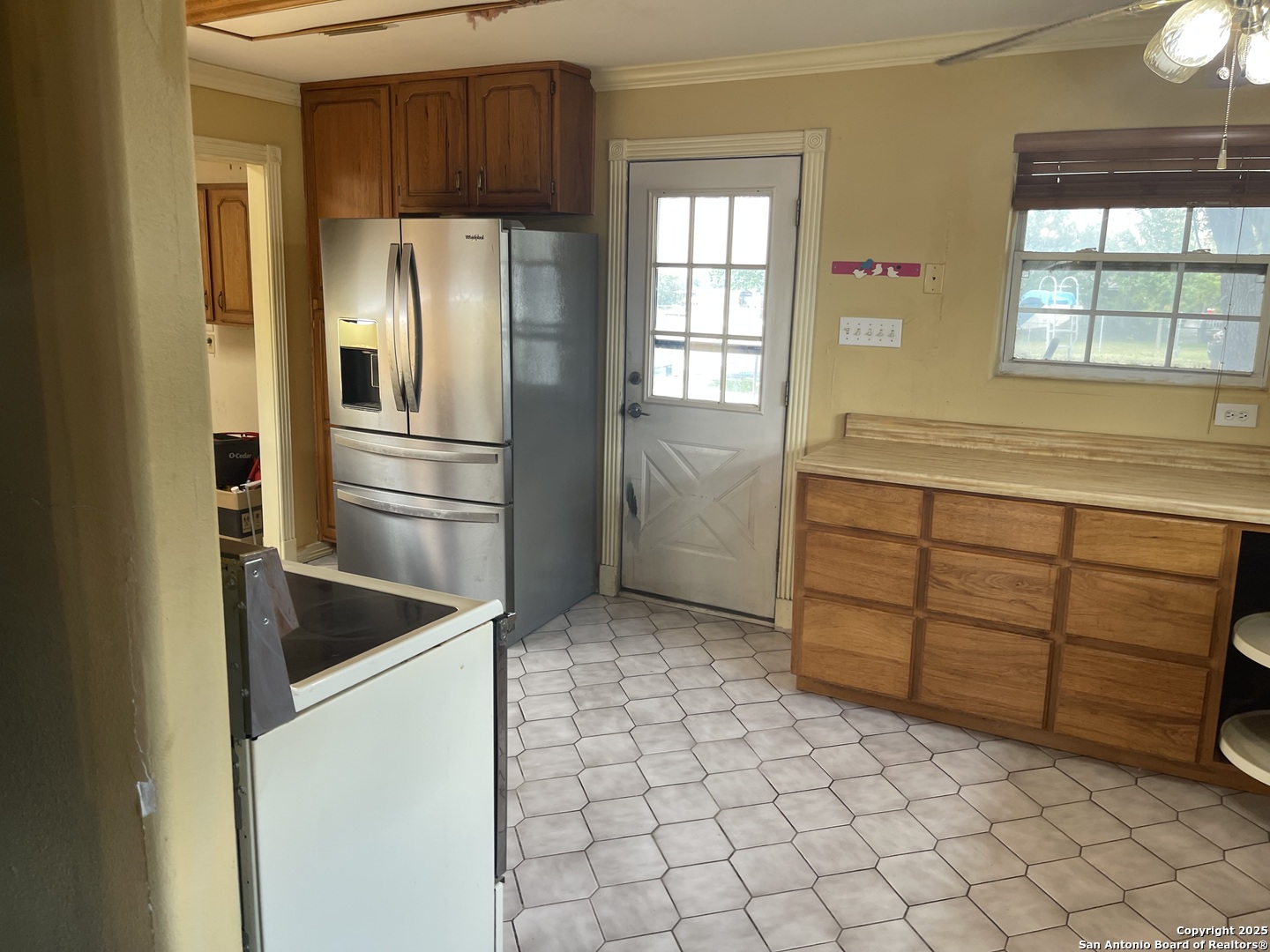 6932 Green Valley Road Cibolo, TX 78108 - Photo 8 of 18 a kitchen with a refrigerator and window