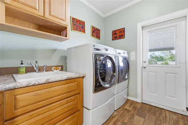 a utility room with sink dryer and washer