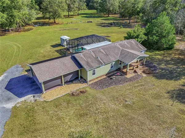 a view of a house with a yard and a swimming pool