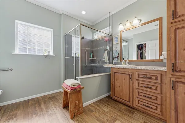 a kitchen with stainless steel appliances granite countertop a sink and wooden floor