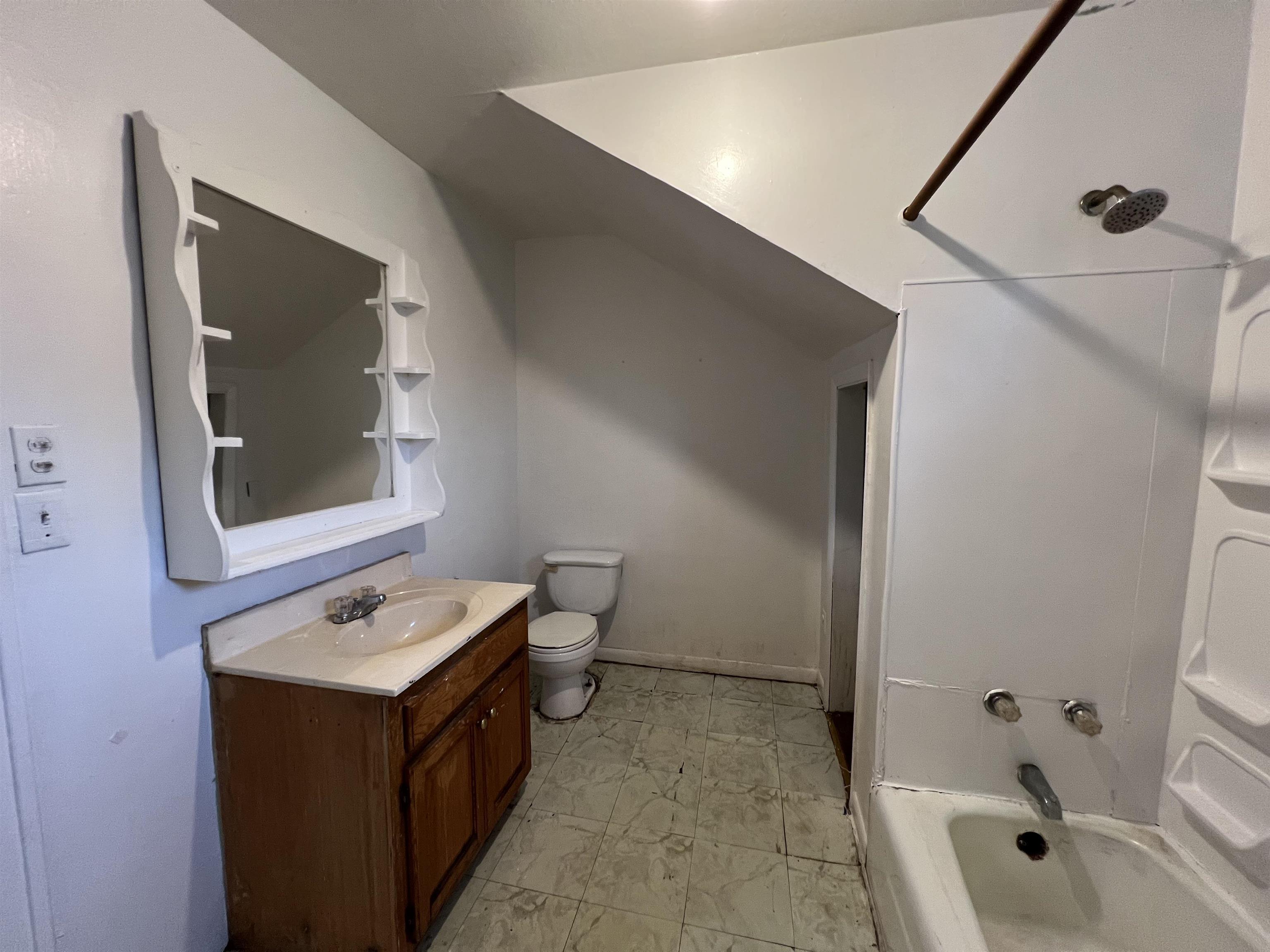 220 Elizabeth Avenue Waynesboro, VA 22980 - Photo 12 of 16 a bathroom with a double vanity sink a mirror and a bathtub