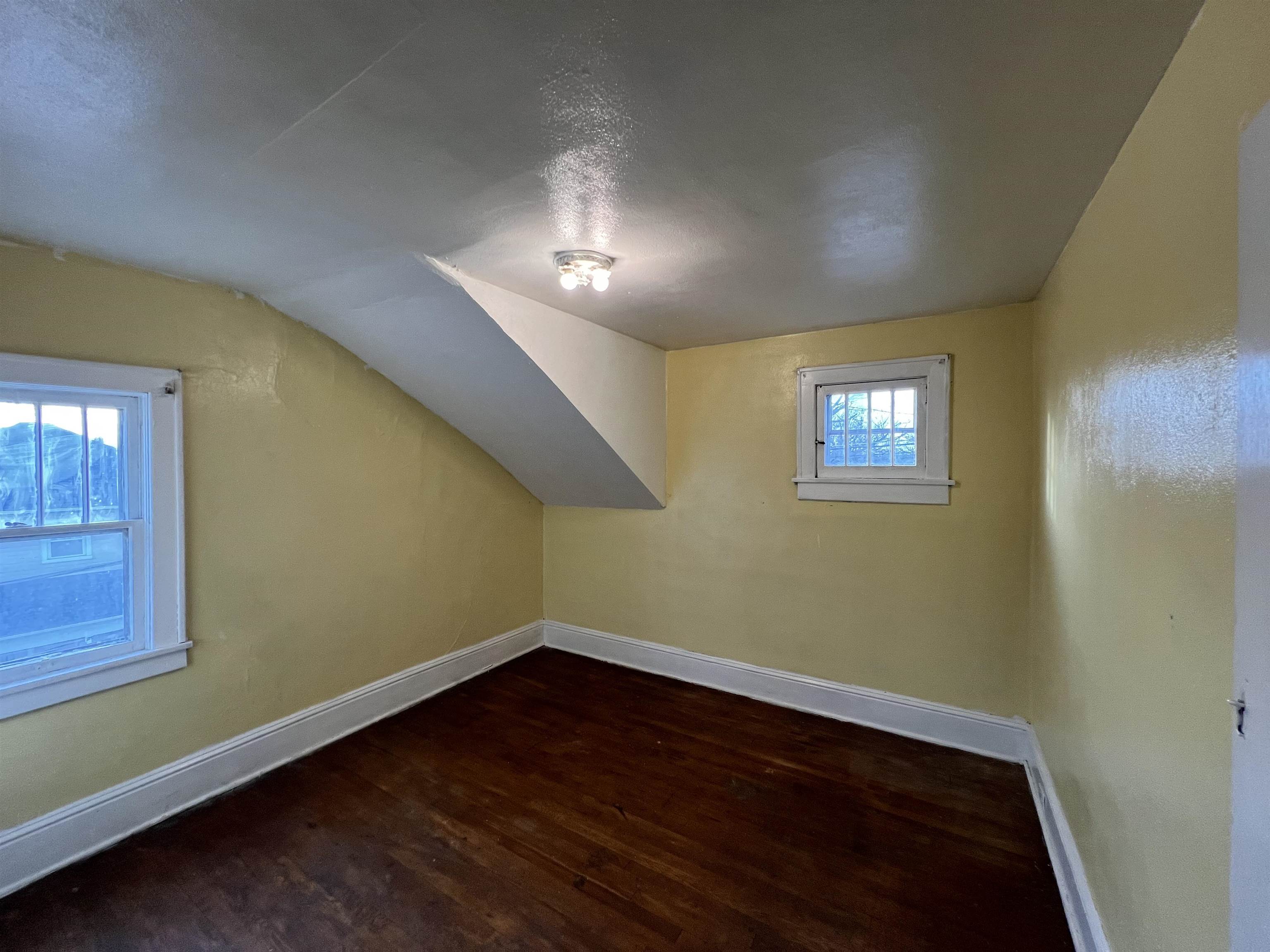 220 Elizabeth Avenue Waynesboro, VA 22980 - Photo 14 of 16 an empty room with wooden floor and windows