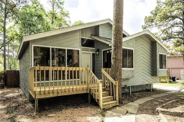 a view of a house with a wooden deck